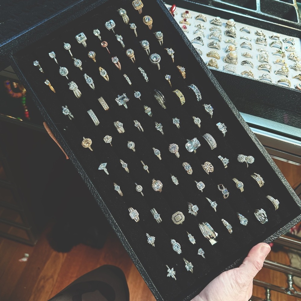 Tray of sterling silver engagement rings in various sizes.